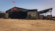The McKenzie Field Hangar is needed to play Oscar Guzman Flies Again (Image via Rockstar Games)